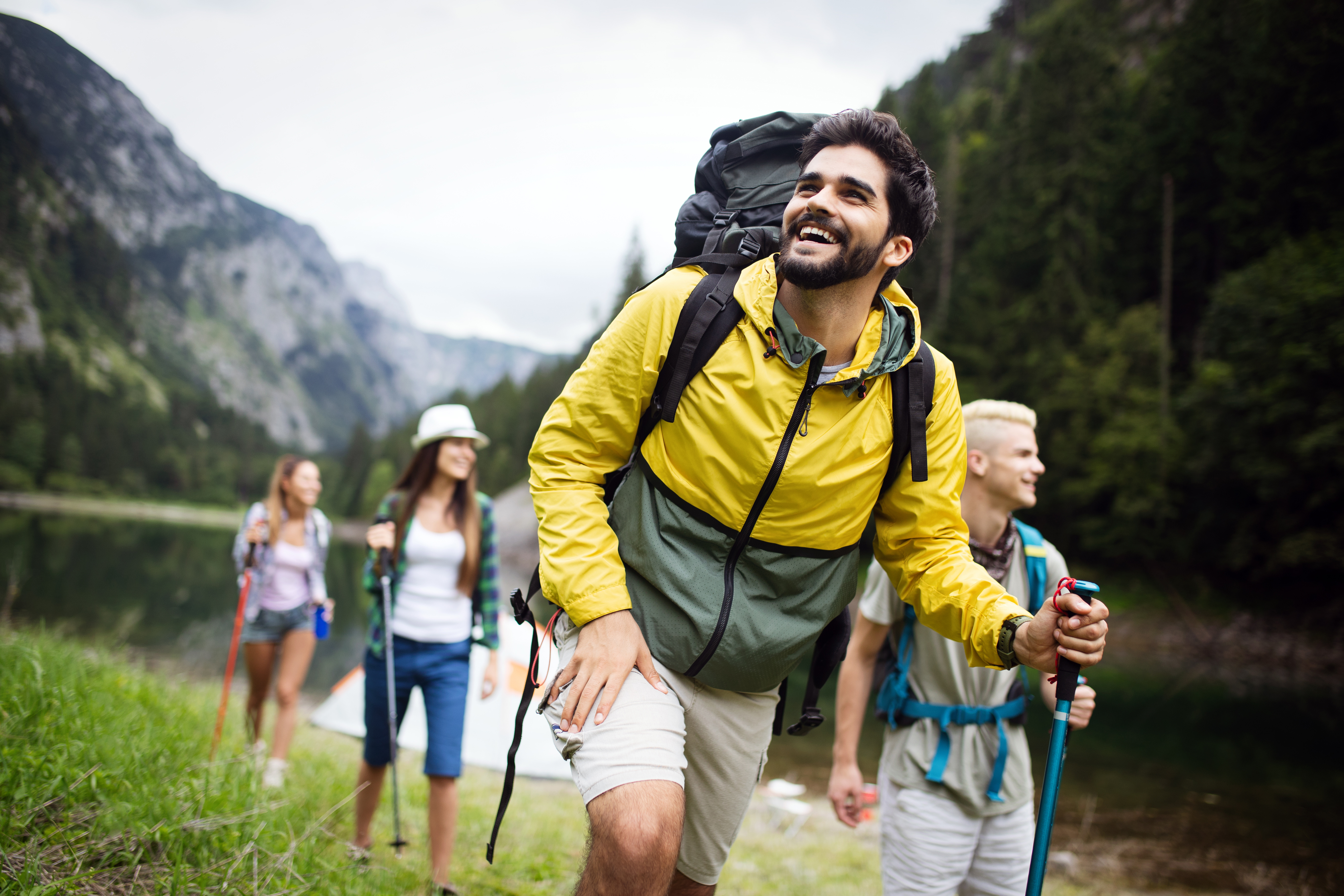 Group of young friends hiking in countryside. Multiracial happy people
